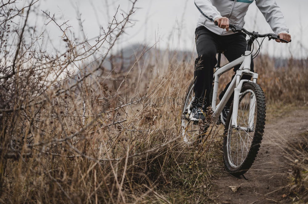 Similar – Mann beim Wandern mit Mountainbike