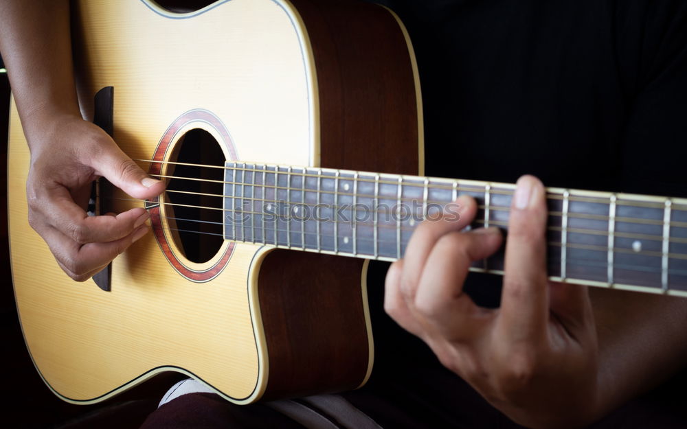 Young man playing acoustic guitar