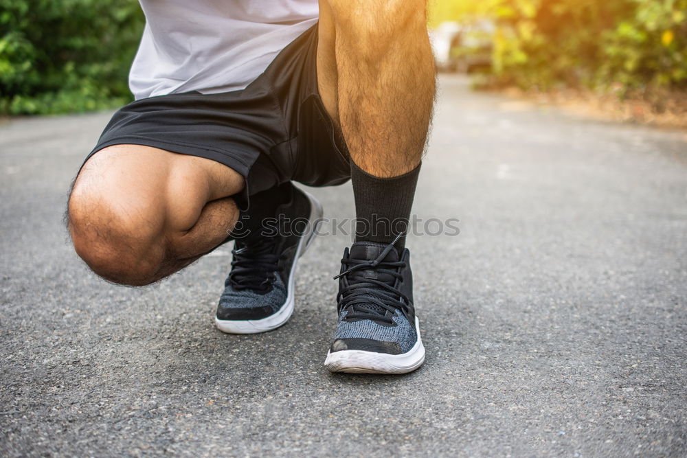 Similar – Runner get ready for run, tying sneakers shoelaces