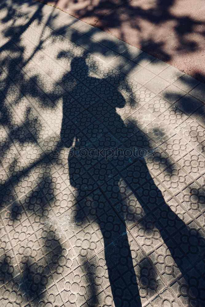 Similar – Schatten von Frau mit Tasche auf Stein