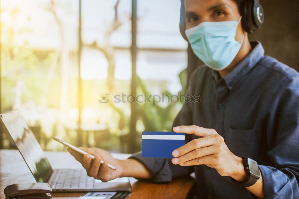 Similar – Young Businessman Wearing Mask Working On Laptop At Hot Desk In Office During Health Pandemic