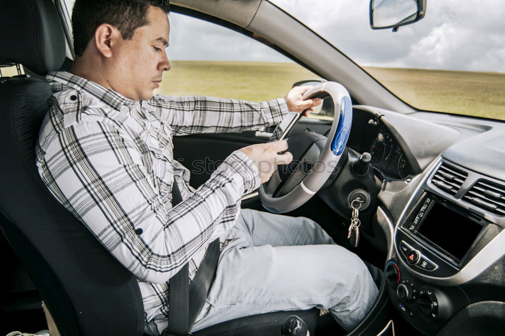 Similar – Image, Stock Photo Young man holding steering driving