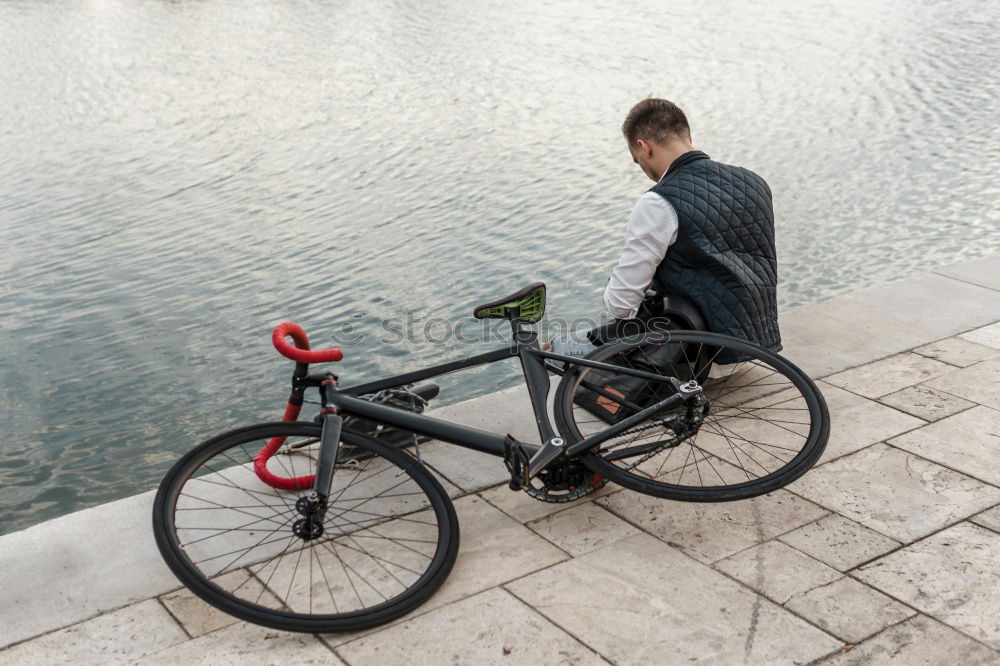 Similar – Mann mit Fahrrad auf Brücke stehend