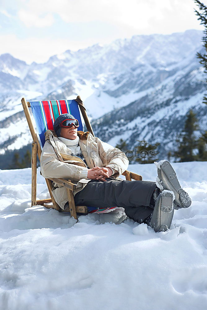 Similar – Sun loungers in the snow in front of mountain panorama