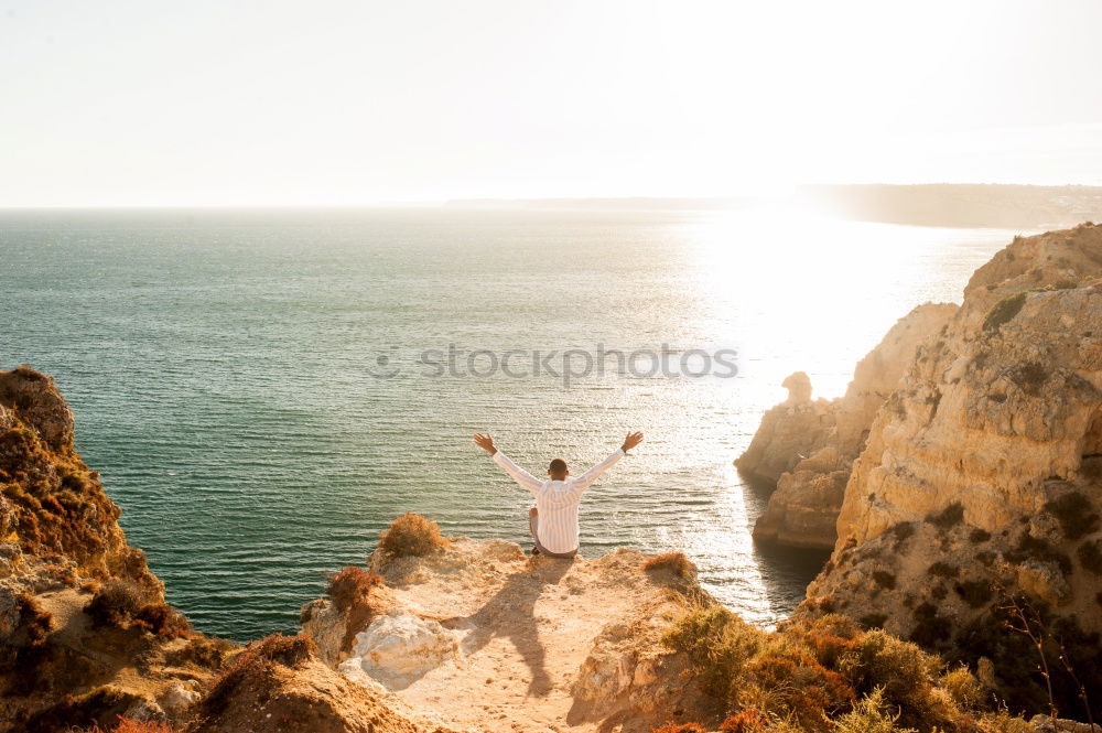 Similar – Image, Stock Photo Men standing on cliff at ocean