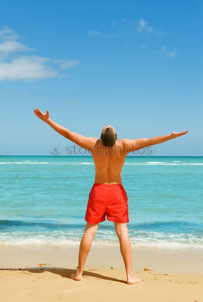 Image, Stock Photo swimmer putting on his wetsuit on the beach