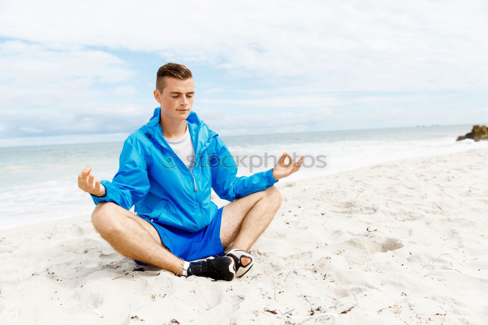 Similar – Young sports man is doing yoga for preparation of his workout