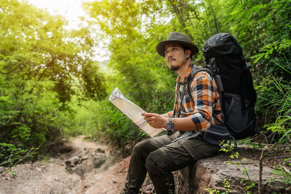 Similar – Man navigating on road in woods