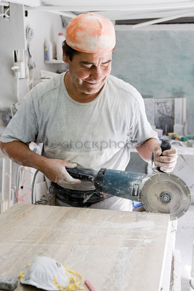 Similar – Carpenter cutting wooden board at his workshop