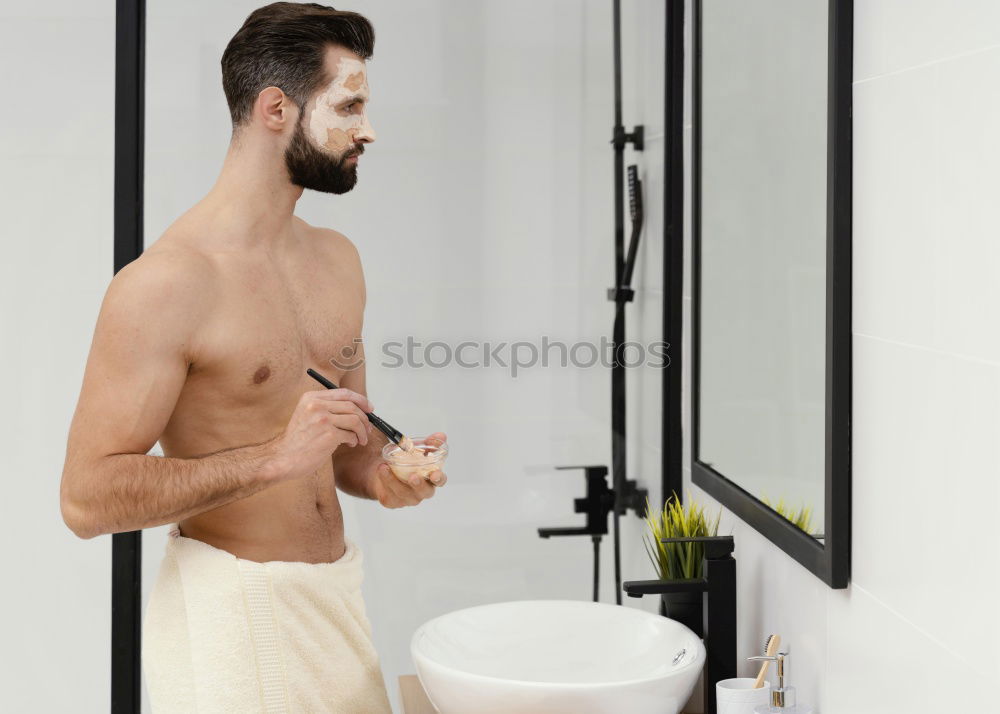 Young man applying shaving cream