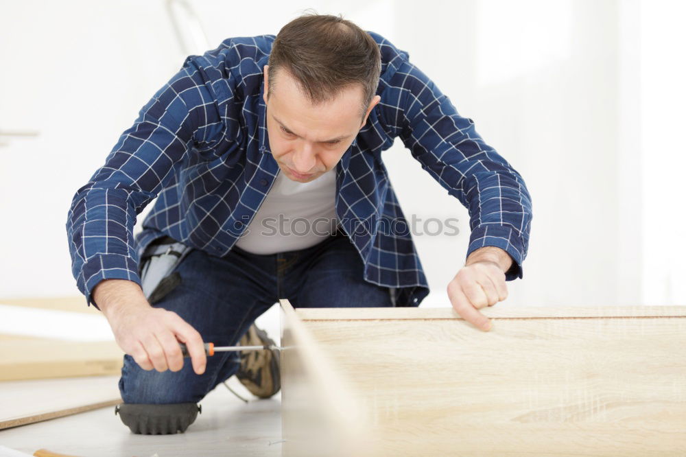 Similar – Worker with corner and pencil in hand