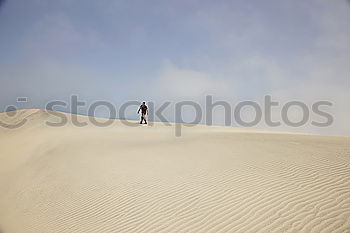 Similar – Image, Stock Photo Anonymous man walking on sand hills