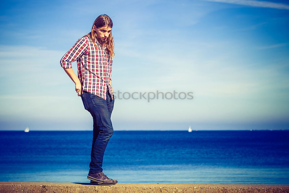 Man holding hands at seaside