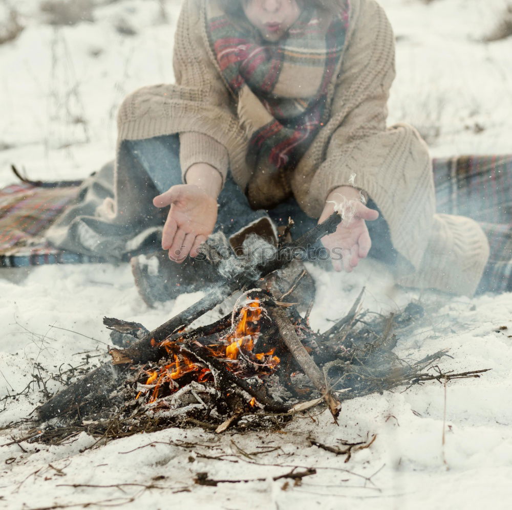 Similar – Family spending time together outdoors in the winter. Parents with children gathered around the campfire preparing marshmallows and snacks to toasting over the campfire using wooden sticks