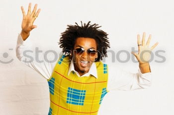 Similar – Image, Stock Photo Black man with afro hair putting on sunglasses. Sunglasses and a