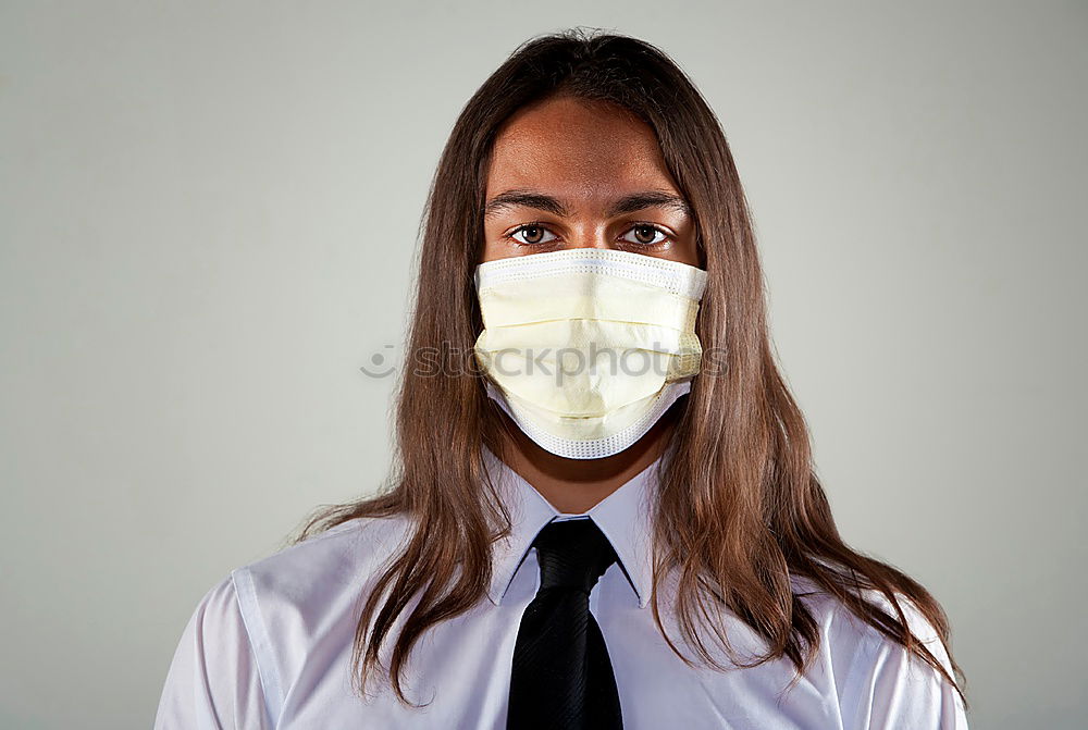 Similar – young woman who is wearing a mask under her nose in the wrong way