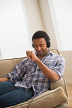 Image, Stock Photo Portrait of a young thoughtful mixed race man sitting in the sofa