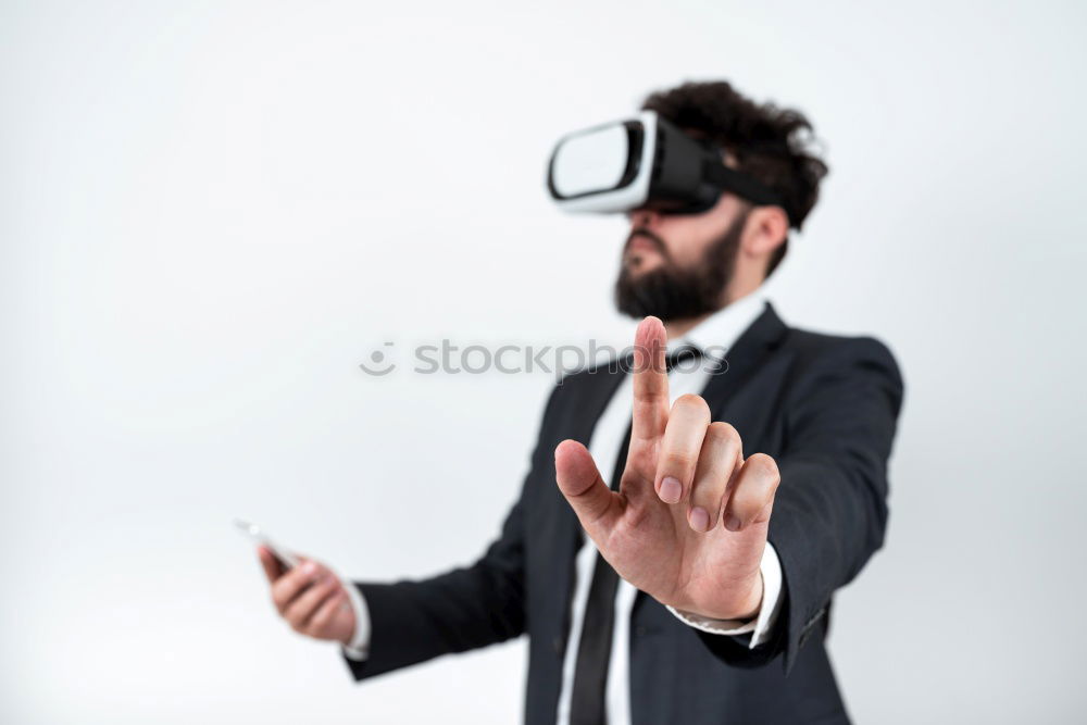 Similar – Foto Bild Ein Mann, der sich eine Virtual-Reality-Brille ansieht.