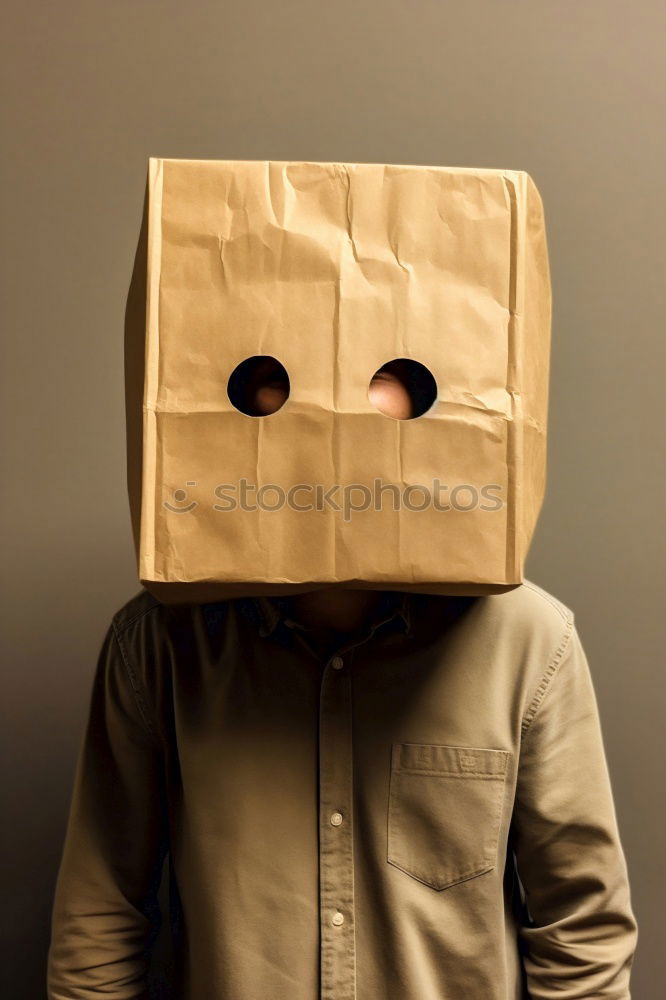 Similar – Person with paper bag on head pointing at camera