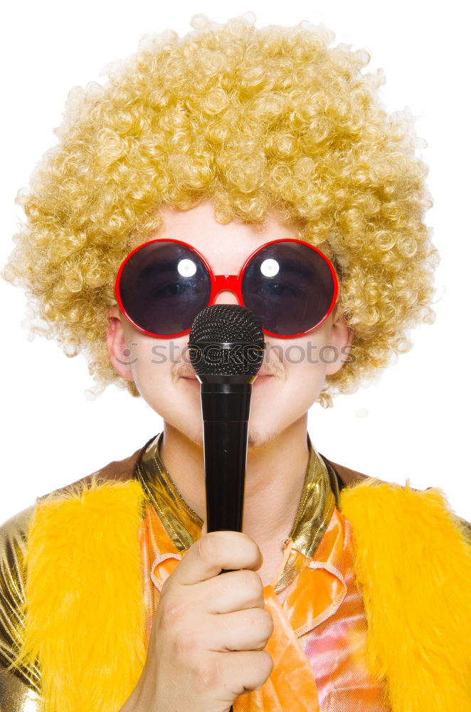 Woman with monkey mask posing against a yellow background