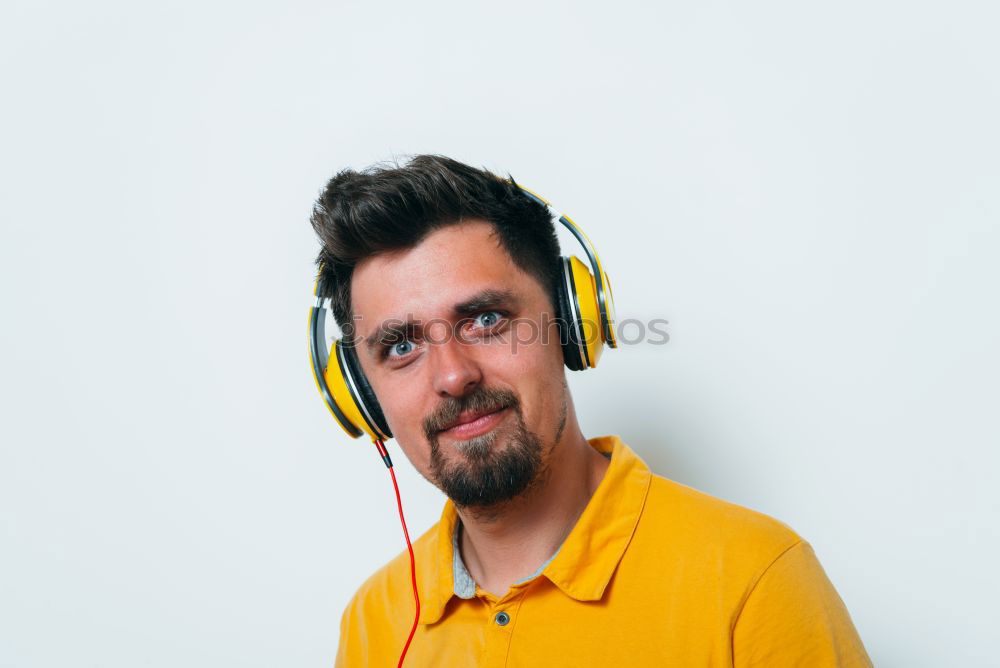 Similar – Man listens to music through Bluetooth headphones