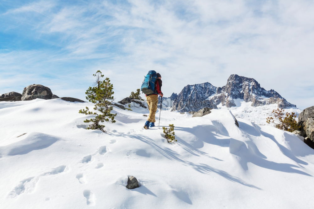 Similar – Image, Stock Photo Man walking through snow on a mountain peak