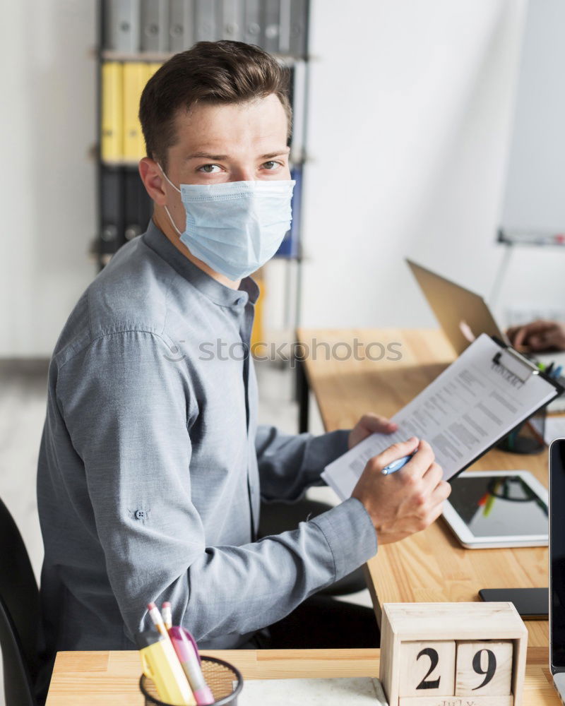 Similar – Young Businessman Wearing Mask Working On Laptop At Hot Desk In Office During Health Pandemic