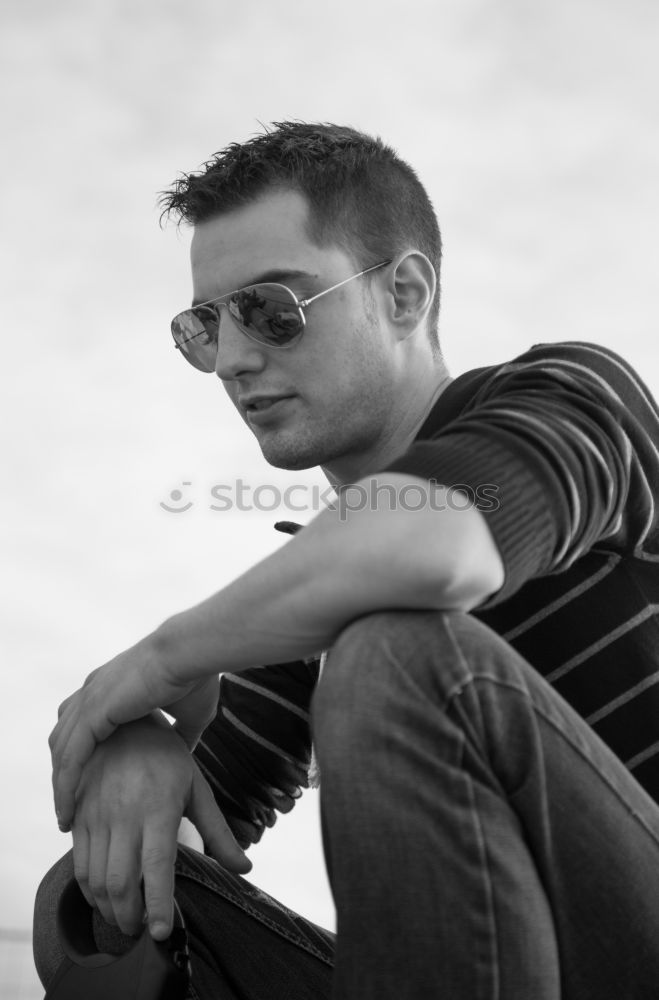 Similar – Boy with a white T-shirt in front of a dark wall