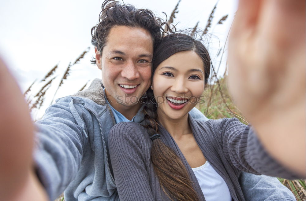 Similar – Young couple taking selfie photo with smartphone outdoors