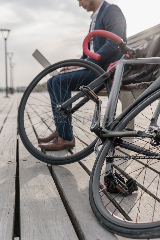 Similar – Mann mit Fahrrad auf Brücke stehend