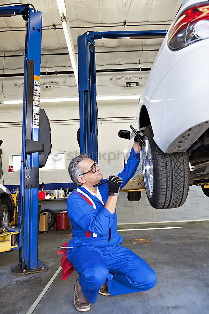 Similar – Image, Stock Photo Mechanic checking motorcycle