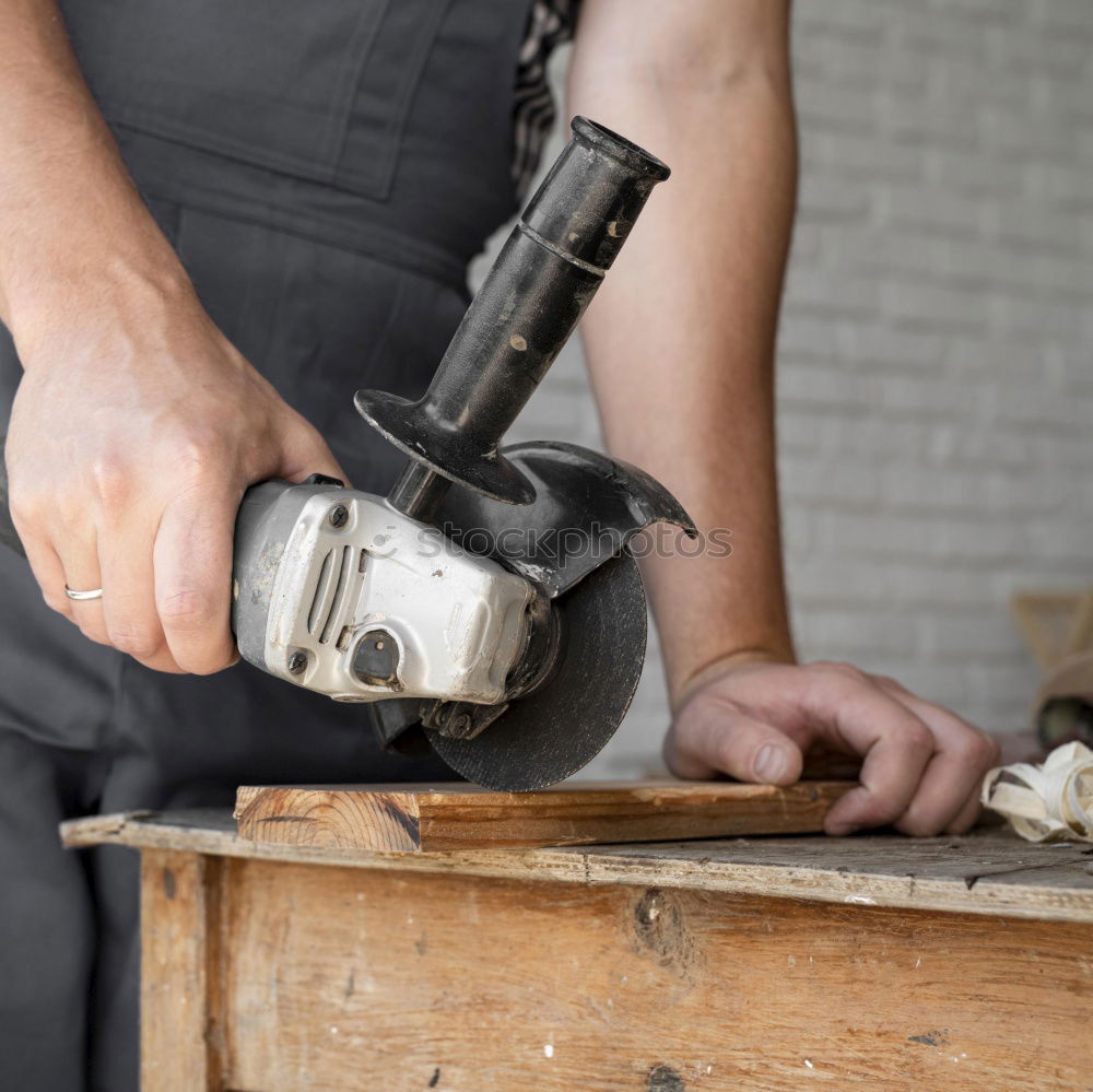 Similar – Man shoeing horse near stable