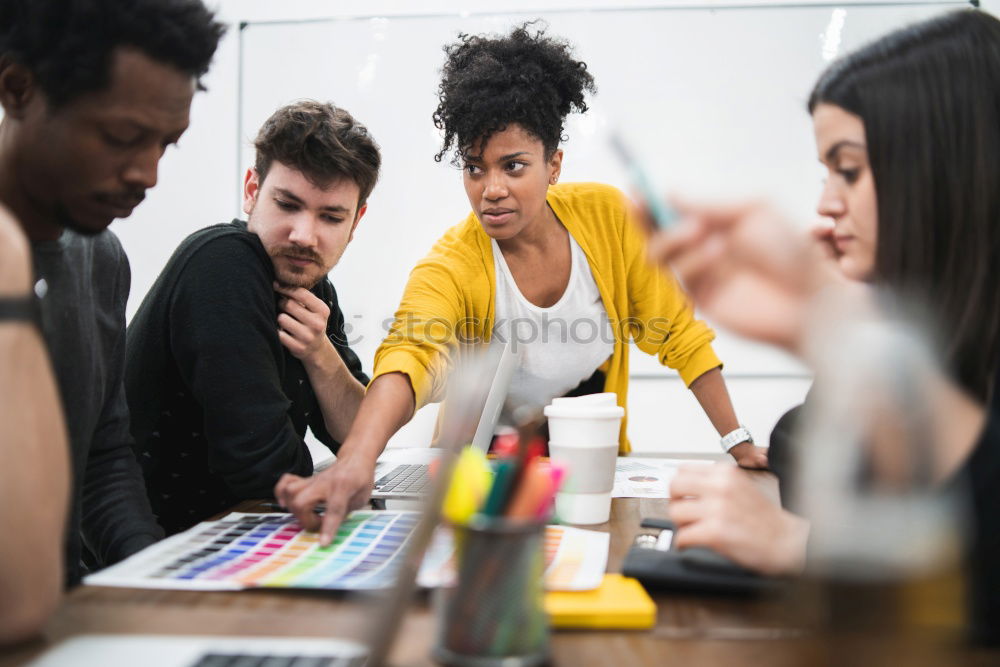 Group of young adults having a meeting in the office