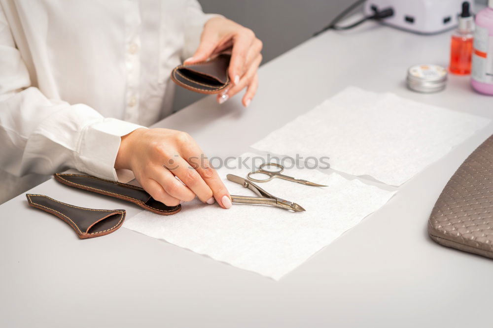 Similar – Close up on woman’s hands sewing needle and thread. Old woman working wasted hands .Tailor sewing some fabric. Details, low light, moody