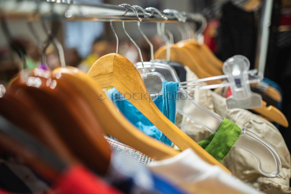 Similar – Kleidung auf einer Kleiderstange im Second Hand Geschäft oder auf dem Flohmarkt