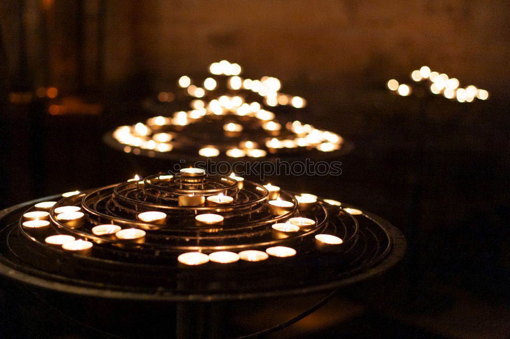 Similar – Image, Stock Photo Theme day: diverse/candlelight, candle offering in a church. Many candles are placed on a staircase. With dark background.