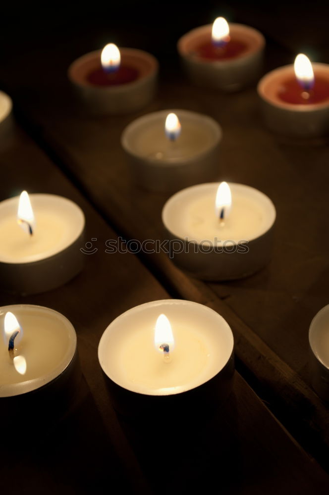 Similar – Advent arrangement with four candles. In the background the blurred lights of the Christmas tree.