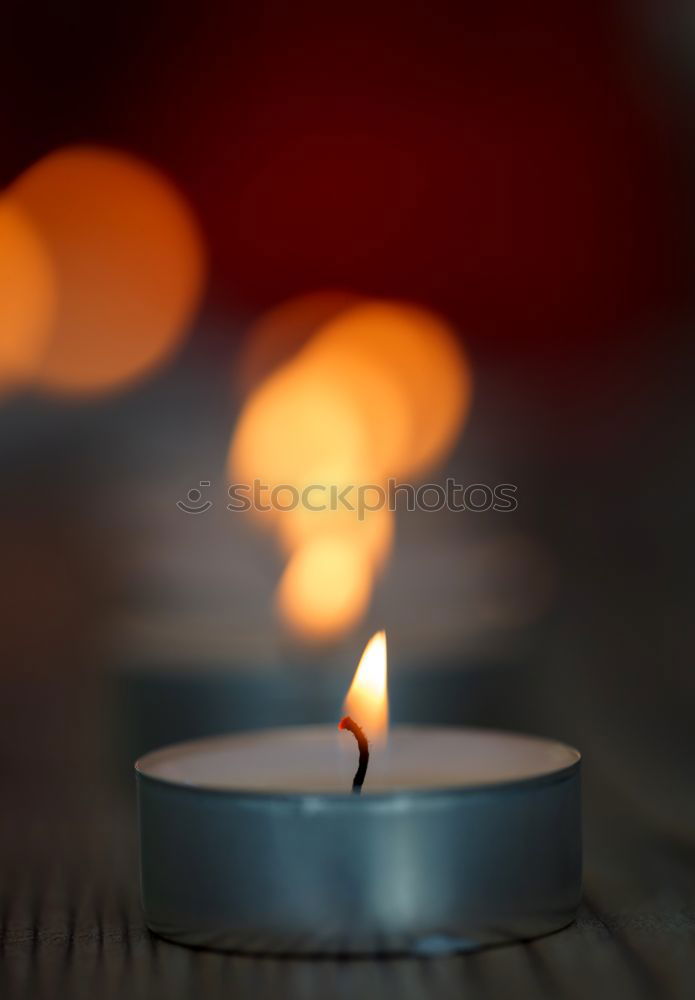 Similar – Advent arrangement with four candles. In the background the blurred lights of the Christmas tree.