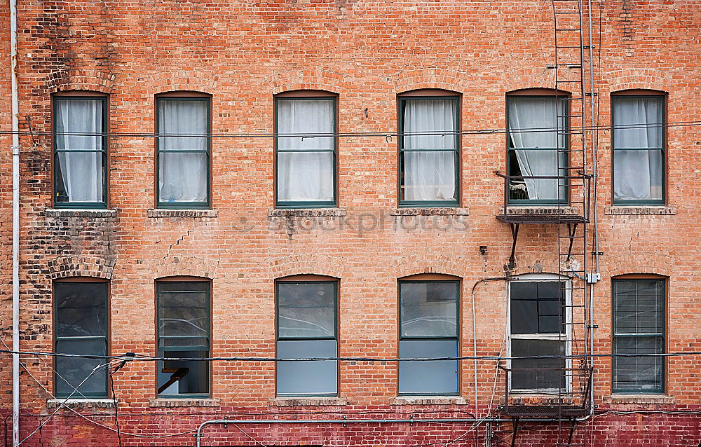 Similar – Two windows of a warehouse with red clinker and closed windows