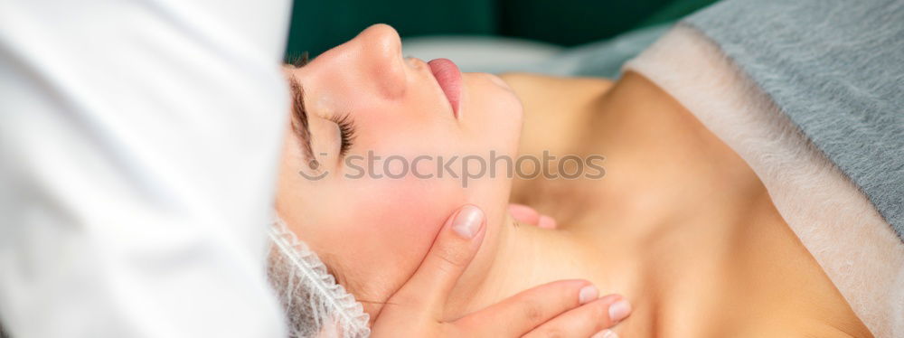 Similar – Massage therapist doing lymphatic drainage treatment to woman