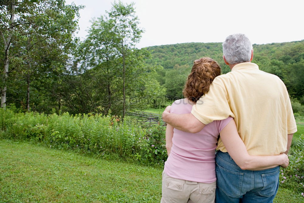 Image, Stock Photo 2 seniors in love are sitting on a bench in the vineyard and look into the Ahr valley. The man points to something.