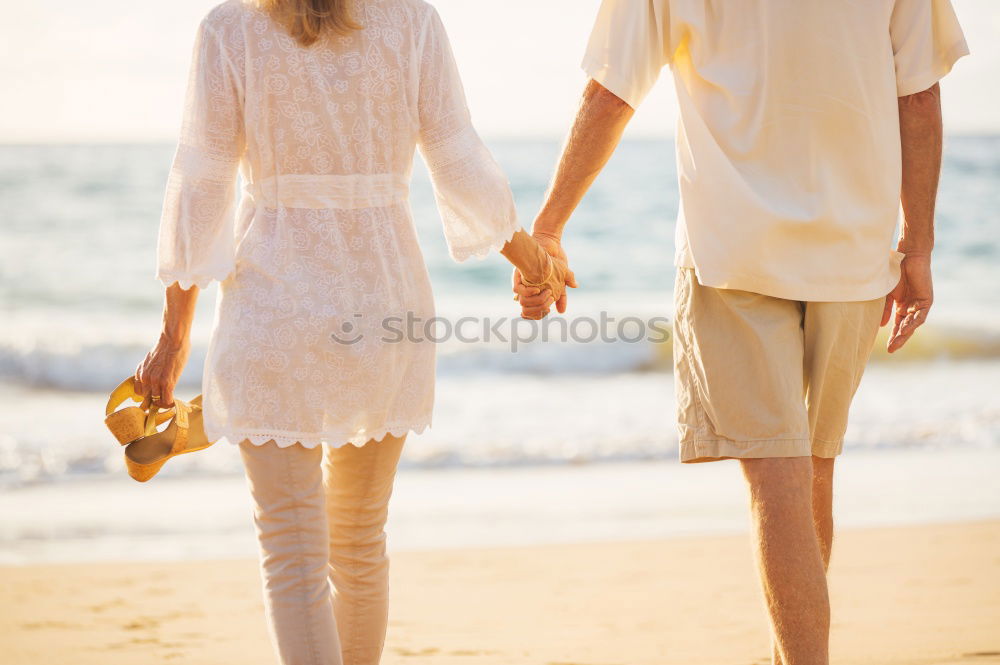 Similar – Closeup of couple holding hands