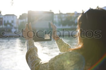 Image, Stock Photo two friends in the street taking pictures with mobile phone