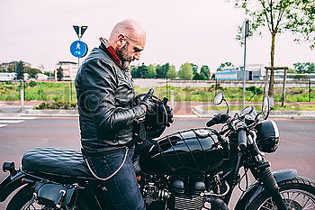 Similar – Image, Stock Photo Biker checking with a motorcycle