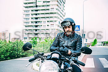 Similar – Man on bike at garage