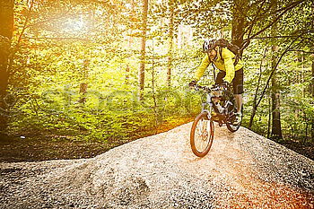 Similar – Young cyclist on the edge of a rock ready to jump