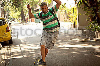 Similar – Portrait of young skateboarder man with bad boy face in the middle of the street.