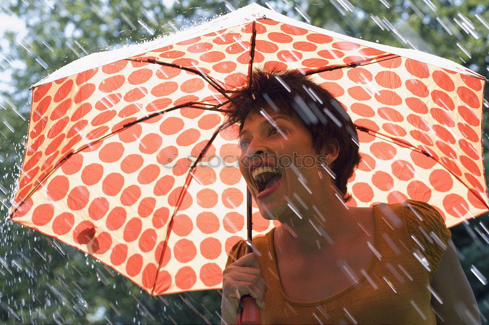 Image, Stock Photo A long haired blonde woman ducks under red umbrella in rainy weather