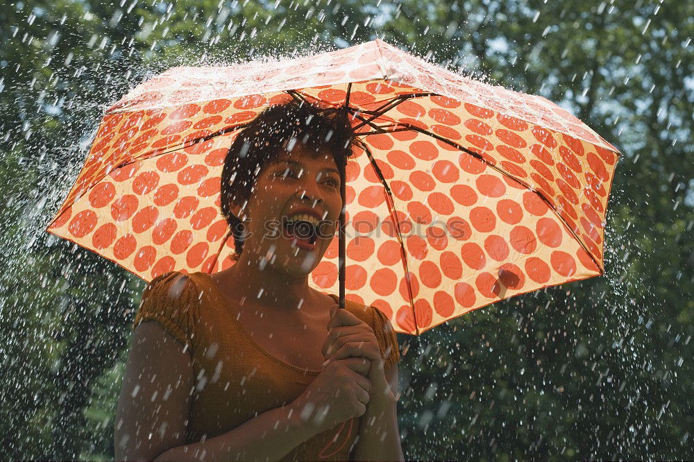 Similar – Image, Stock Photo A long haired blonde woman ducks under red umbrella in rainy weather