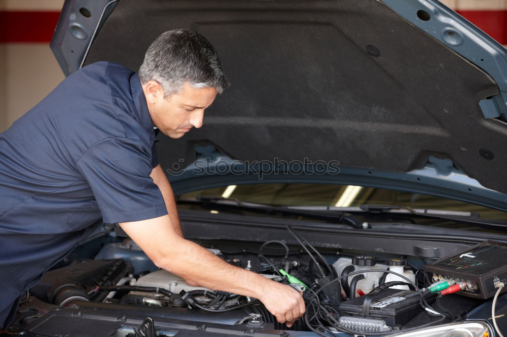 Similar – Professional Mechanic Repairing Car.